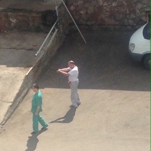 Очевидцы засняли мужчину с пистолетом на территории красноярской краевой больницы